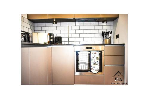 a kitchen with stainless steel cabinets and an oven at Modern 2 Bed 2 Bath Bracknell with Free Parking in Bracknell
