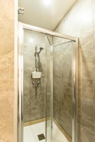a shower stall with a sink in a bathroom at Modern, Bright & Spacious Apartment near the sea in Marsaskala