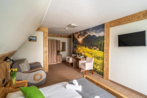 a room in a hotel with a mural of a farm at Hotel Eco Tatry Holiday& Spa in Kościelisko