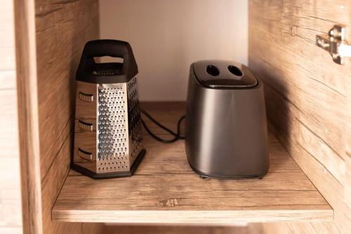 a toaster and a box on a shelf in a drawer at Modern, Bright & Spacious Apartment near the sea in Marsaskala