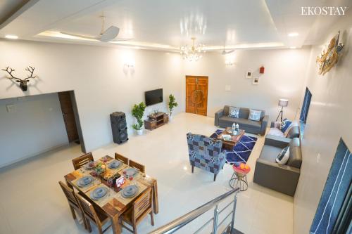 an overhead view of a living room with a table and chairs at Ekostay Gold Palm Estate I Cricket Turf I Rain Dance I 2 Acre Property in Karjat