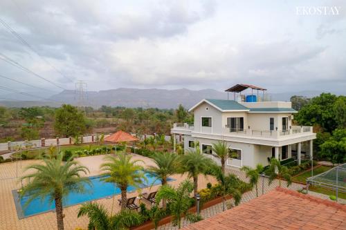 an aerial view of a house and a swimming pool at Ekostay Gold Palm Estate I Cricket Turf I Rain Dance I 2 Acre Property in Karjat