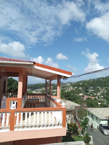 a balcony of a house with a view of a city at Angie's Cove, modern get-away overlooking Castries in Castries