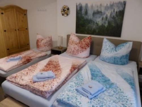 two beds with pillows on them in a room at Ferienwohnung in 09548 Seiffen bis maximal 18 Personen in Kurort Seiffen