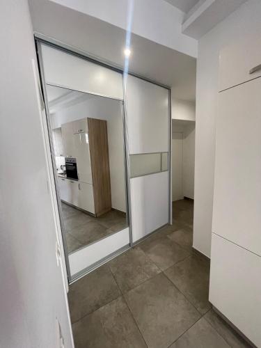 a large mirror in a room with a kitchen at Plaza Teatro & Piazzale Teatro in Rijeka