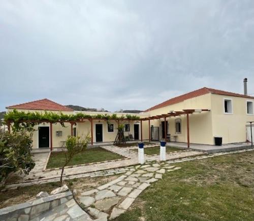 a house with a walkway in front of it at Villa Rosa in Kattavía