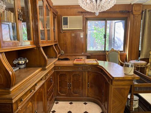 a kitchen with a wooden desk and a window at 4-Brs Historical Apt in Maadi 5-Min to Nile in Cairo