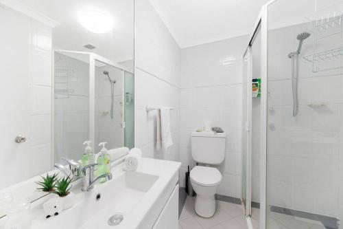 a white bathroom with a toilet and a shower at Sky-view 2B2B1G in Hurstville -1 min to Westfield in Sydney