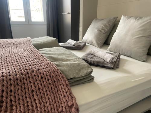 a bed with two pillows and a blanket on it at Plaza Teatro & Piazzale Teatro in Rijeka