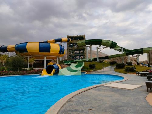 a water slide in a pool at a resort at Eastern El-Galala Aquapark Ain Sokhna in Ain Sokhna