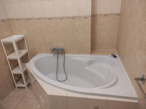 eine Badewanne mit einem Wasserhahn im Bad in der Unterkunft centrumplażaGiżycko in Giżycko