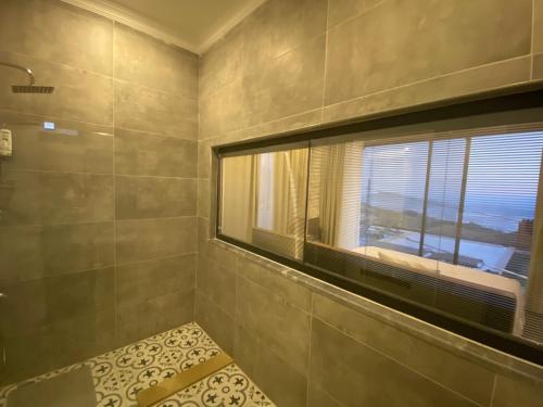 a bathroom with a window and a shower at Villa Ghizlane in Kas