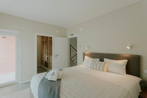a bedroom with a large bed with a towel on it at Best Houses 108 - Casa Sea Mountain in Ferrel