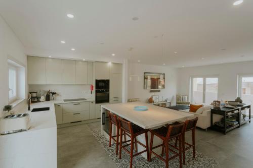 a kitchen and living room with a table and chairs at Best Houses 108 - Casa Sea Mountain in Ferrel