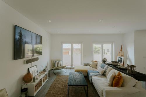 a living room with a couch and a table at Best Houses 108 - Casa Sea Mountain in Ferrel