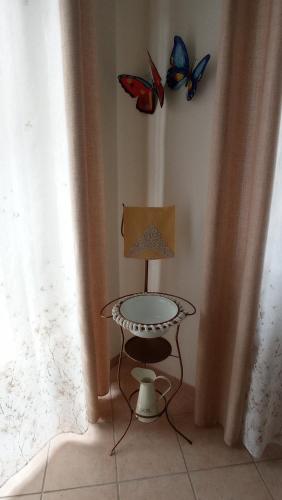 two butterflies on the wall next to a table at LA CASA DEI MASUE' in Alba