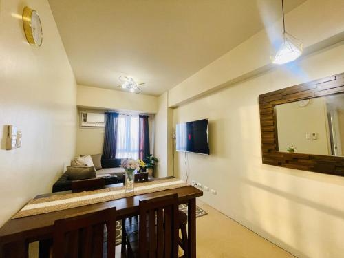 a living room with a table and a mirror at Sunset View 1-BR Unit at Centrio Tower beside Ayala Mall Downtown CDO in Cagayan de Oro