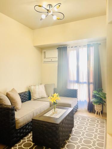 a living room with a couch and a table at Sunset View 1-BR Unit at Centrio Tower beside Ayala Mall Downtown CDO in Cagayan de Oro