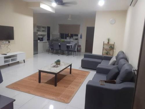 a living room with a couch and a table at Belian Homestay Sibujaya in Sibu