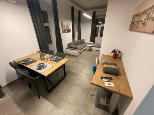 a living room with two tables and a couch at Plaza Teatro & Piazzale Teatro in Rijeka