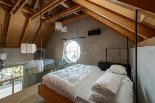 a bed in a room with a glass wall at Aparthouse Lubno in Frýdlant nad Ostravicí