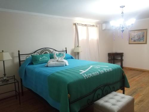 a bedroom with a bed with a blue comforter at Apartamento Solar dos Castanheiros in Prainha de Baixo