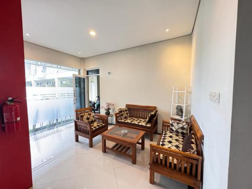 a living room with couches and a table at FAKHIRA RESIDENCE HOTEL in Cianjur