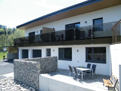 a building with a balcony with a table and chairs at Haus Schloßbergblick in Leutschach