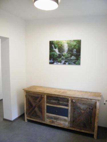 a room with a wooden cabinet with a television on it at Haus Schloßbergblick in Leutschach