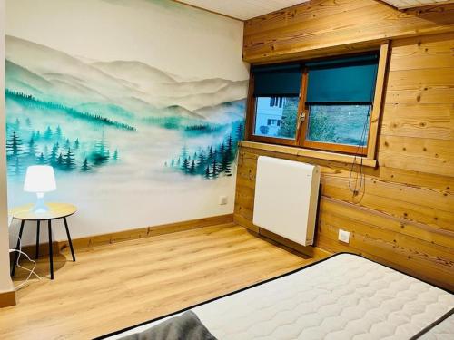 - une chambre ornée d'une peinture murale dans l'établissement Appartement La Galerie de Mémé, à Gérardmer