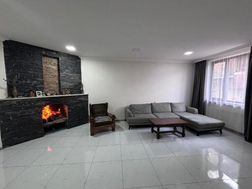 a living room with a couch and a fireplace at Friendly House in Akhaltsikhe