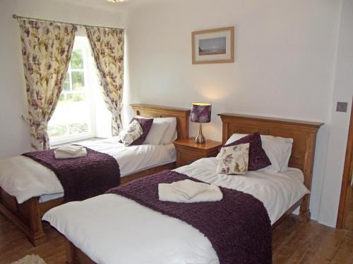 A bed or beds in a room at Penalltcych Farmhouse Abercych