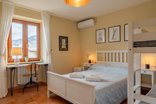 a bedroom with a bed and a desk and a bed at Garda Doma in Brenzone sul Garda