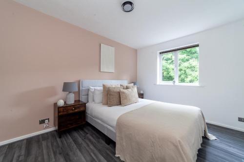 a white bedroom with a bed and a window at The Peckham Collection in London