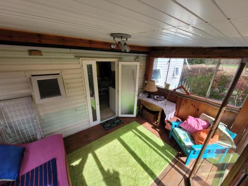 a view of a screened in porch of a tiny house at Mobile home toutes saisons in Beauzac