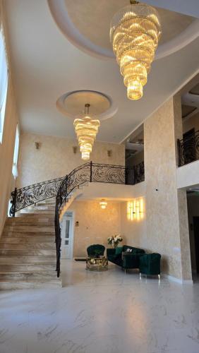 a large lobby with a staircase and chandeliers at Hotel Măgura Jina in Jina