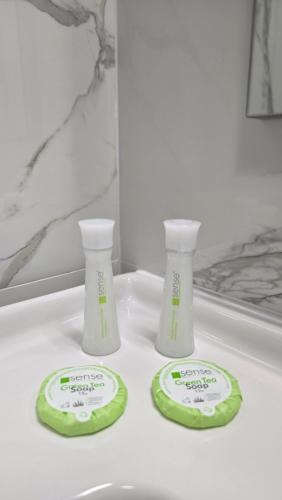 two bottles ofodorizers sitting on a bathroom sink at Hotel Măgura Jina in Jina
