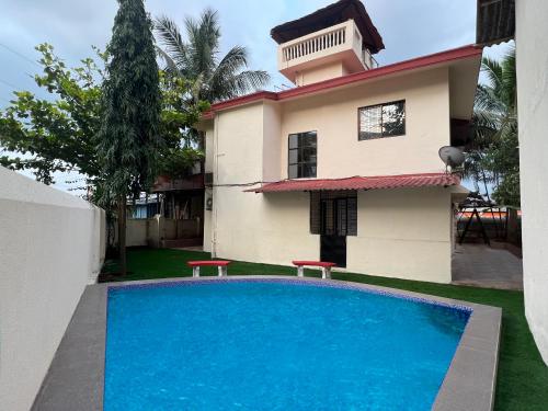a house with a swimming pool in front of a house at El Casa Just 250m From Imagica Private Villa With Pool & BBQ in Khalapur