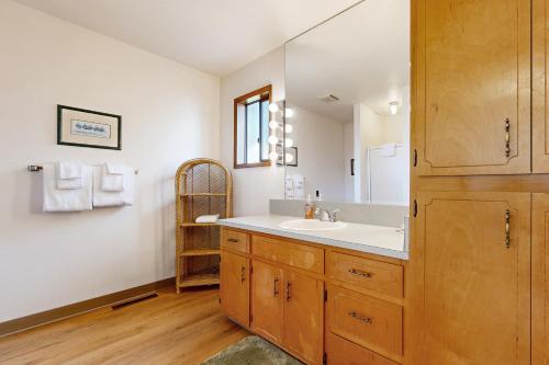 a bathroom with a sink and a mirror at 2 Bed 2 Bath Vacation home in Waldport in Waldport