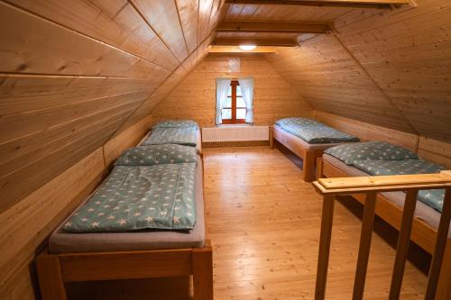 a room with three bunk beds in a cabin at Chata Říp in Rokytnice nad Jizerou