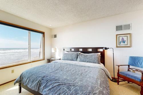 a bedroom with a bed and a large window at 2 Bed 2 Bath Vacation home in Waldport in Waldport