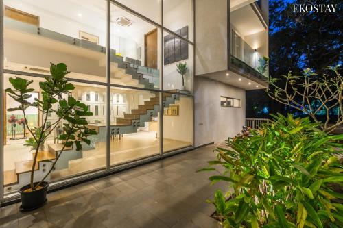 an empty hallway with plants and stairs in a building at EKOSTAY Luxe I Avante Villa in Calangute