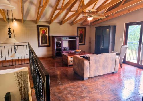 a living room with a couch and a table at Imbabali Retreat & Venue in Magaliesburg
