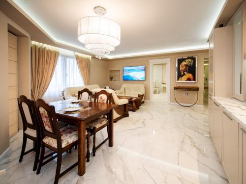 a dining room and living room with a table and chairs at Paradise Center Premium Suite 1 in Sofia