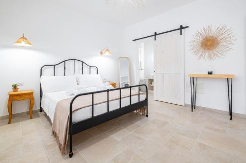 a bedroom with a large bed and a table at Villa Zorro Luxury - Marina di Mancaversa in Marina di Mancaversa