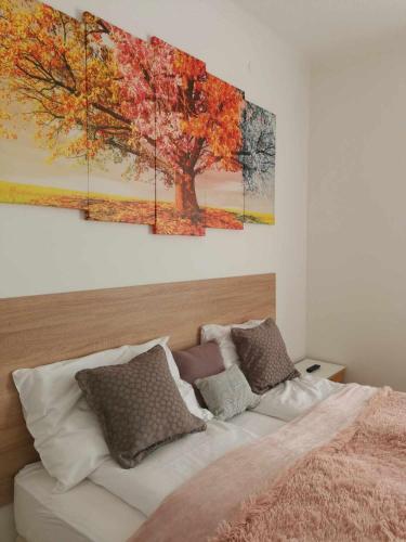 a bedroom with a bed with two paintings on the wall at Eisenerzer Apartments - Radmeisterhaus in Eisenerz