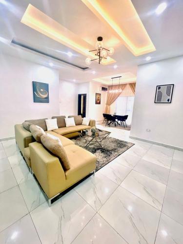 a living room with a couch and a table at White Orchid in Benin City