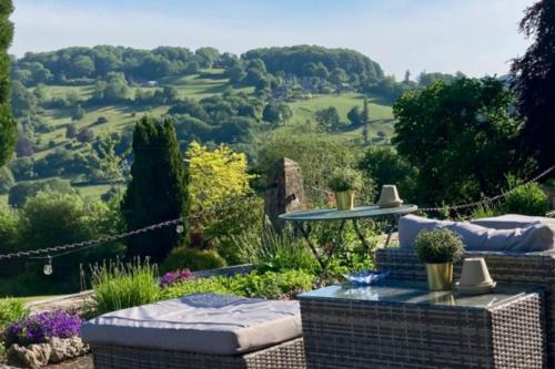 a garden with a view of the hills at Burleigh Court Hotel in Stroud