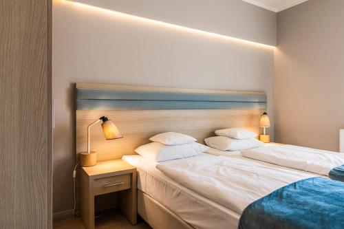 Postel nebo postele na pokoji v ubytování Hotel Cesarskie Ogrody