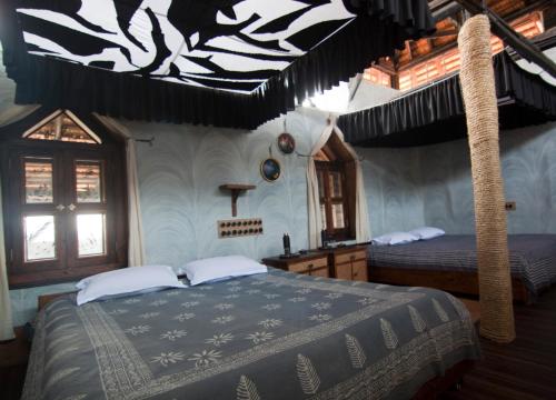 a bedroom with two beds in a house at Olive Branch Farm in Raghunāthpur